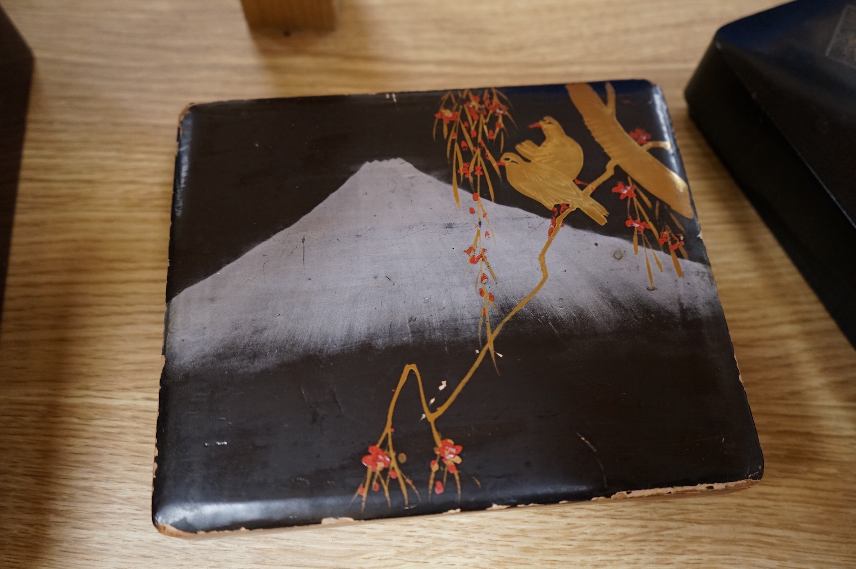 A group of 19th/20th century Japanese lacquer boxes and a similar tabletop cabinet, the latter 31cm wide